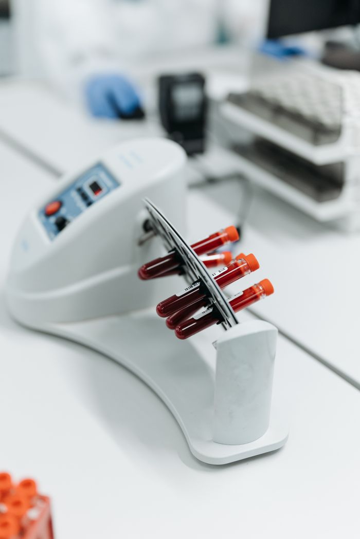 Close-up of a laboratory centrifuge holding blood samples in test tubes.